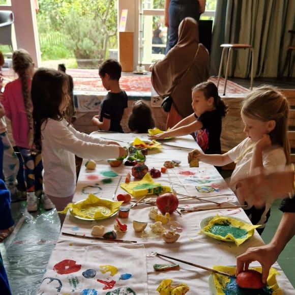 Kinderen maken ambachten met fruit en verf